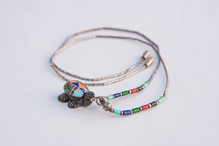 Silver necklace with a stone turtle charm